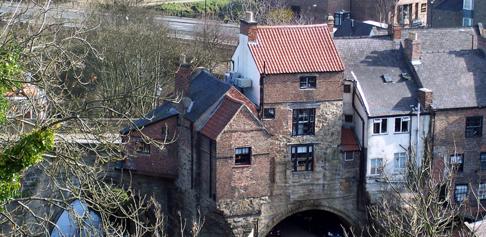 View of the east end of Elvet Bridge, showing the buildings constructed on it. The building to the furthest left still retains the remains of a chapel dedicated to St Andrew.